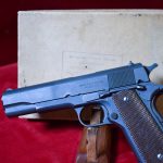 SOLD, RARE & IMPORTANT MARCH, 1943, 1st SHIPMENT ITHACA M1911A1 SERVICE PISTOL, MANUFACTURED WITH RECLAIMED COLT 1911 FRAME, DULITE FINISH & ALL EARLY FEATURES, STILL WITH THE ORIGINAL SHIPPING BOX, MINT CRISP!
